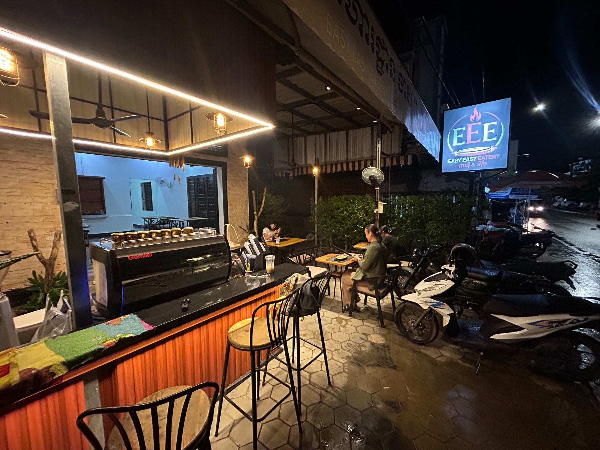 Easy Easy Eatery at night, LED-lit counter with the espresso machine