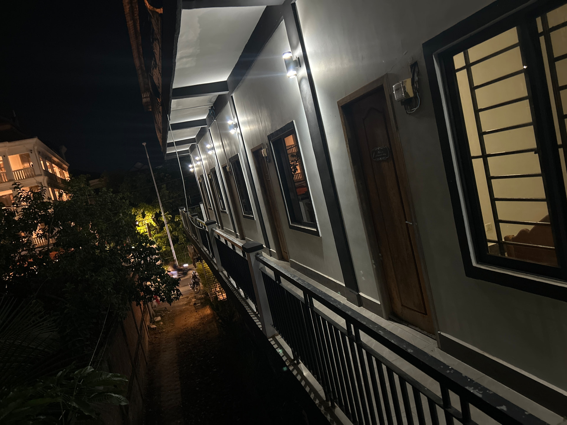 Exterior walkway of the Nomadic Estates guest rooms at night